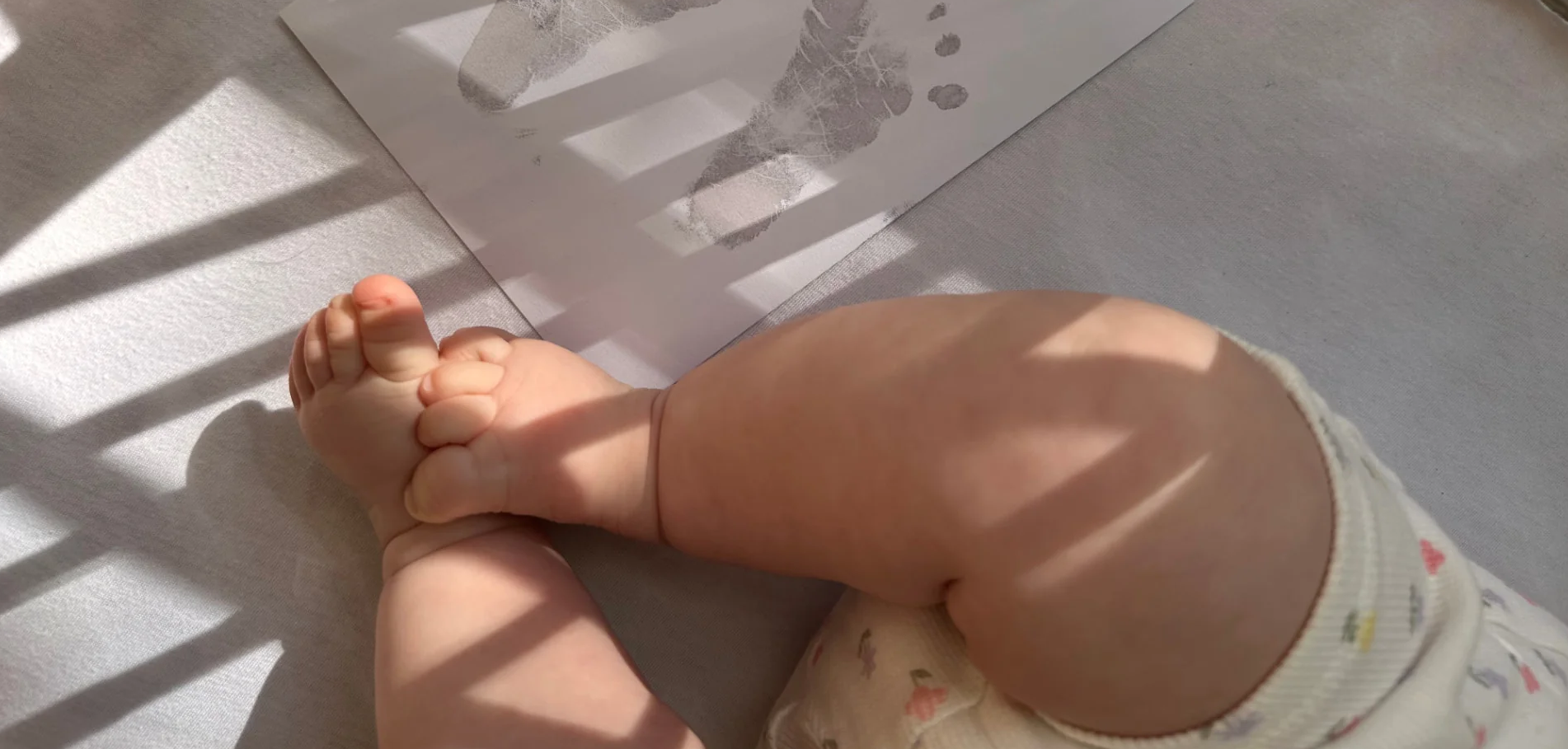 A baby beside an Ari & Me keepsake card