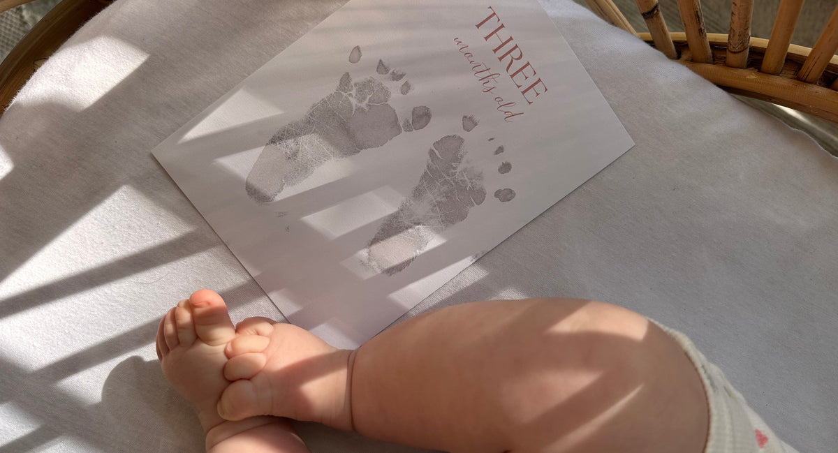 A baby beside an Ari & Me keepsake card